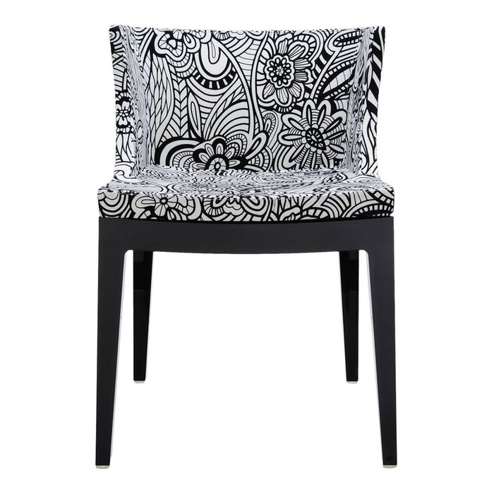 Black and white floral pattern chair with intricate designs and sleek black legs. Ideal for modern decor.