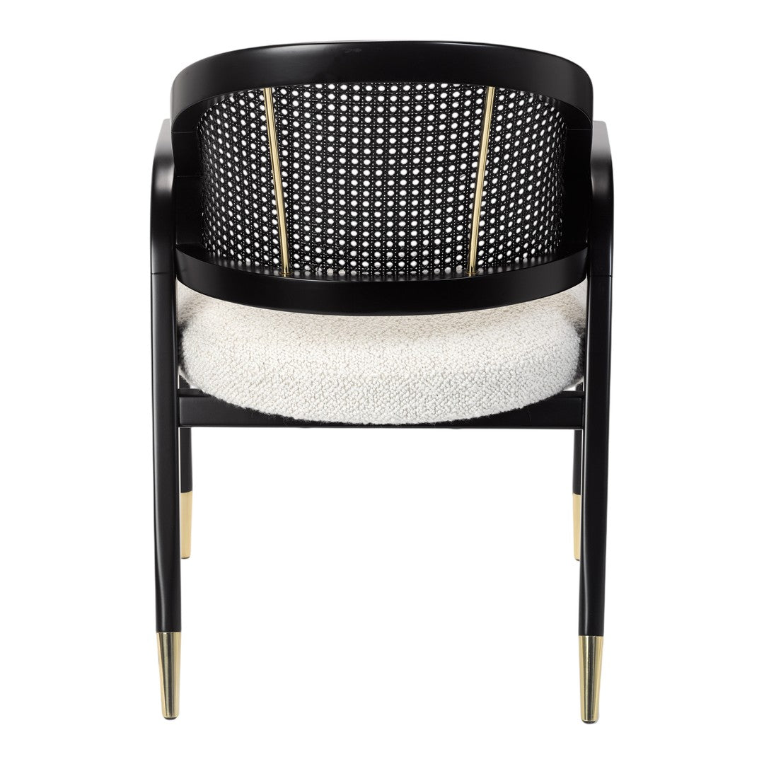 Black chair with a perforated back, white cushioned seat, and gold accents on tapered legs. Elegant modern design.