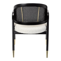 Black chair with a perforated back, white cushioned seat, and gold accents on tapered legs. Elegant modern design.