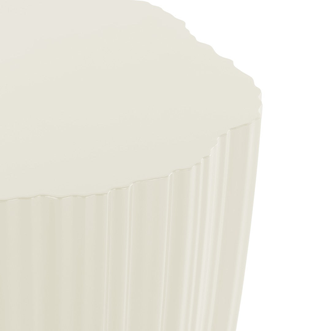 "Round cream-colored tabletop with a textured, ribbed pattern along the edges."