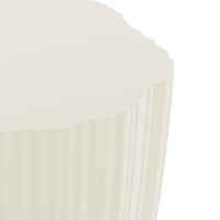 "Round cream-colored tabletop with a textured, ribbed pattern along the edges."