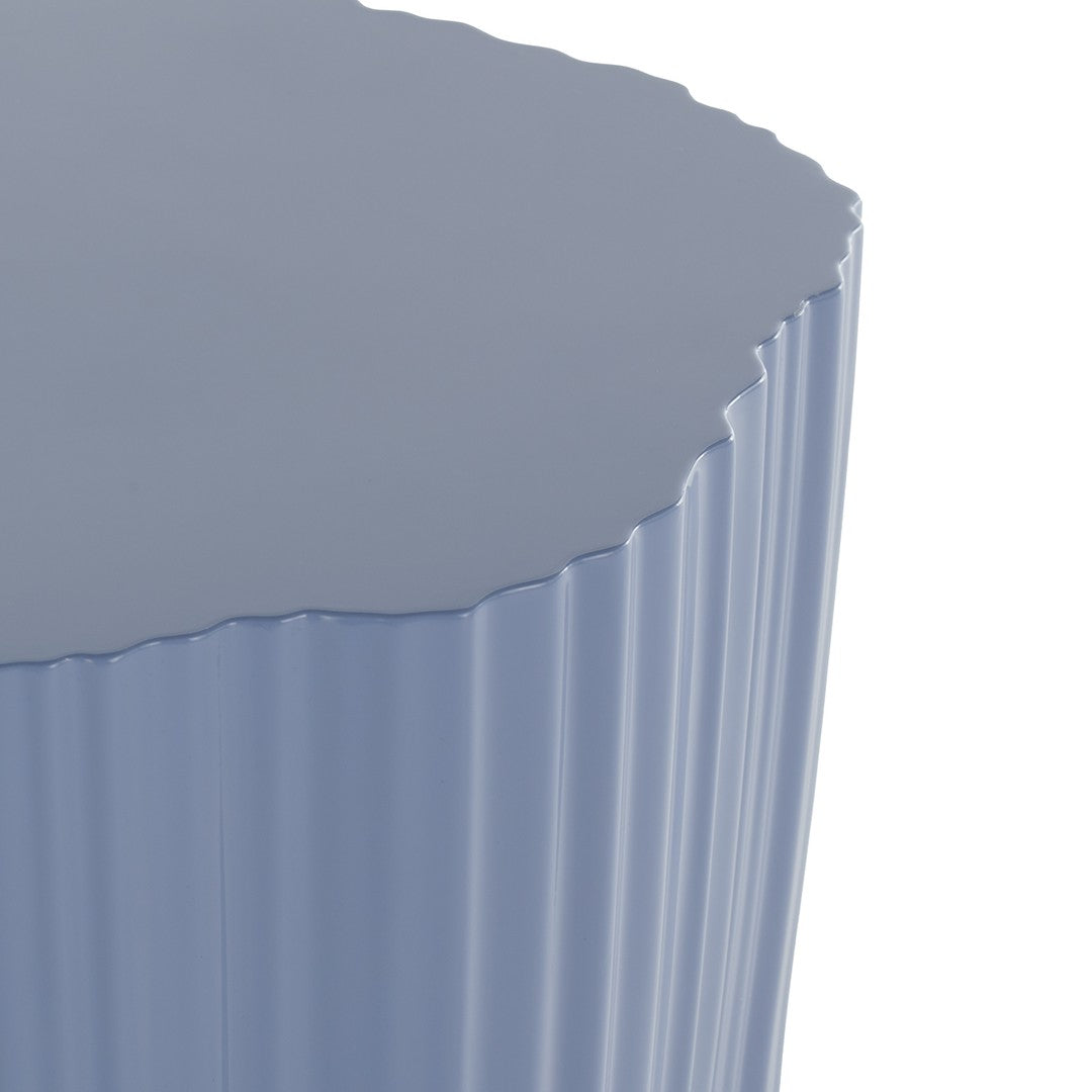 Textured light blue side table with a scalloped edge and ribbed surface pattern, perfect for modern decor.