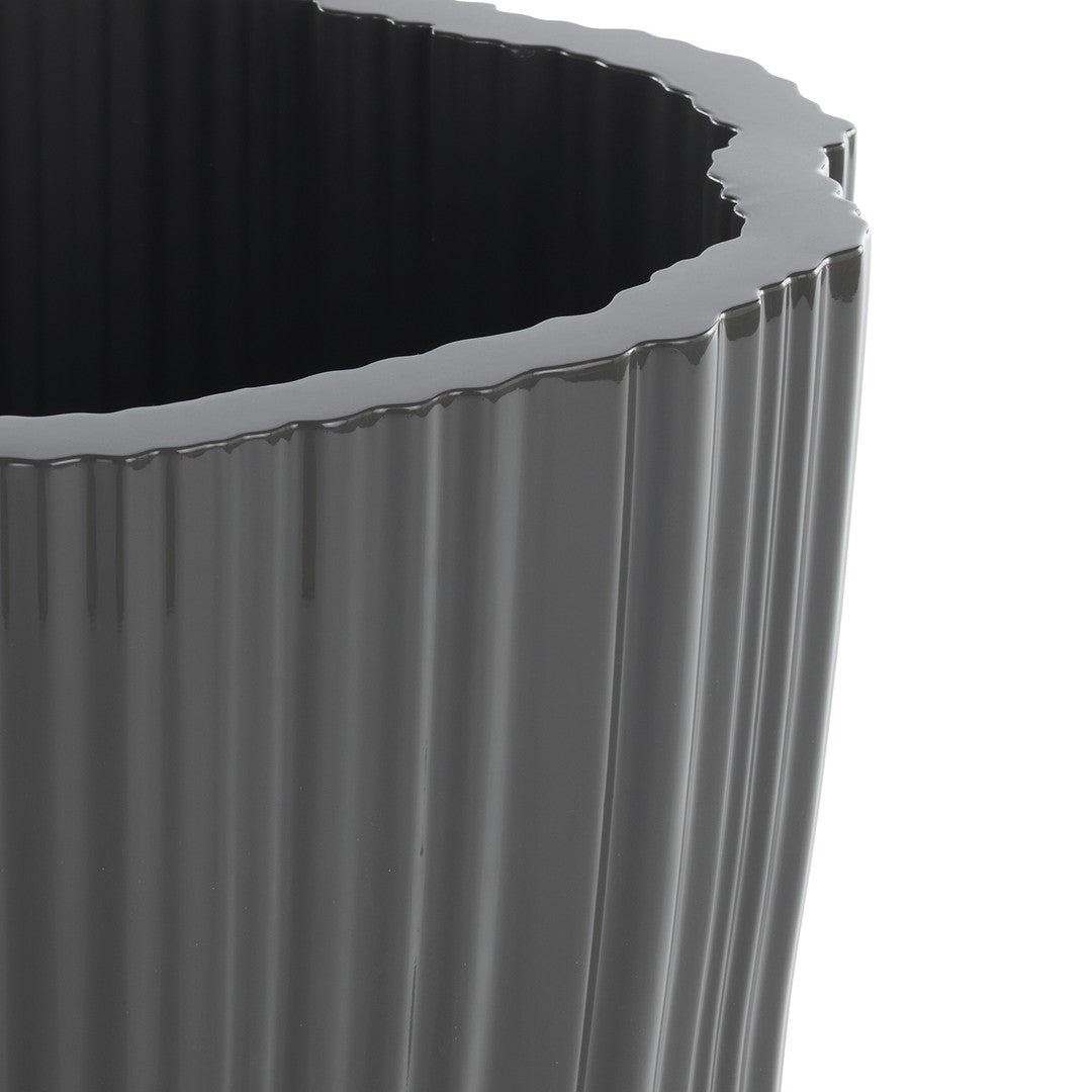 Glossy black planter with ribbed texture and wavy rim, perfect for modern decor.
