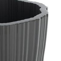 Glossy black planter with ribbed texture and wavy rim, perfect for modern decor.