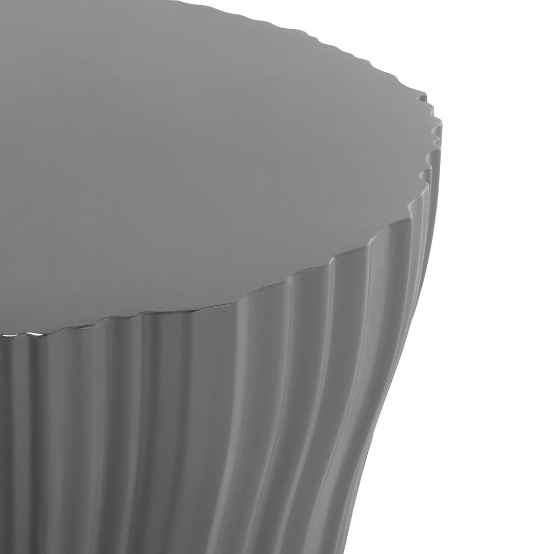 Gray ribbed side table with a glossy finish and wavy top edge, adding a modern touch to home decor.