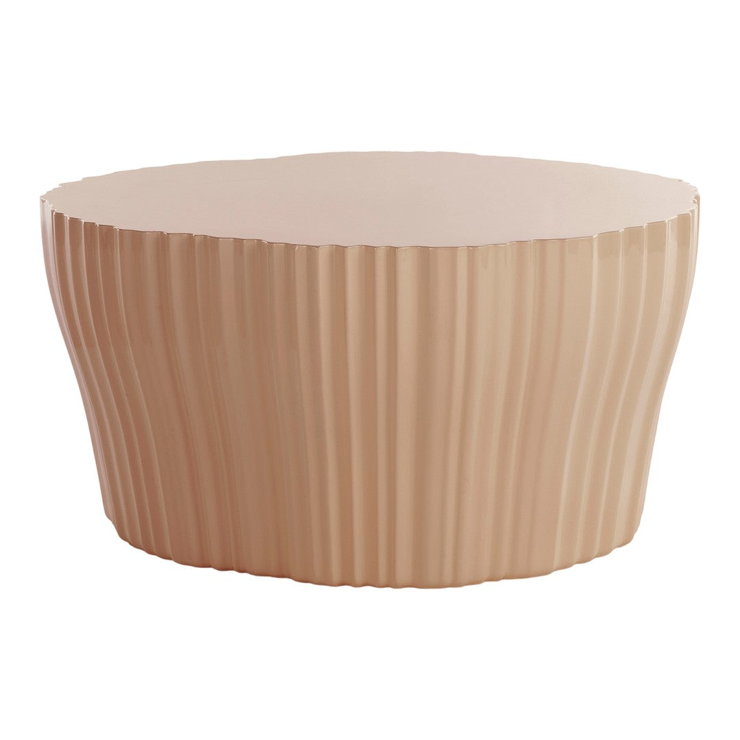 Blush pink round table with textured ribbed pattern, perfect for modern decor.
