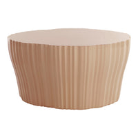 Blush pink round table with textured ribbed pattern, perfect for modern decor.