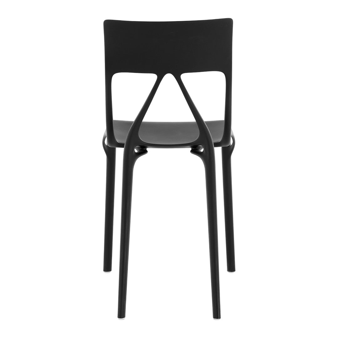 Black modern chair with a minimalist design and smooth finish, featuring a unique cutout pattern on the backrest.