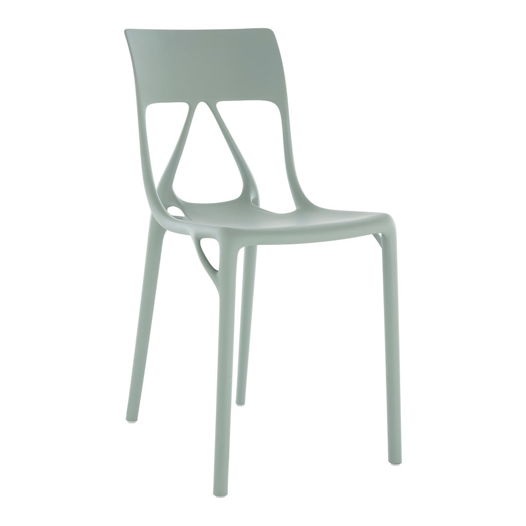 Light green chair with a modern design, featuring smooth curves and cutout patterns for a sleek look.