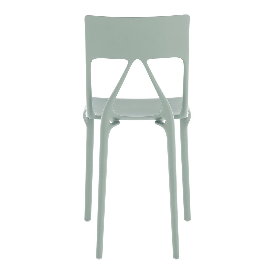 Light mint green chair with a sleek and modern design, featuring smooth, solid plastic construction.