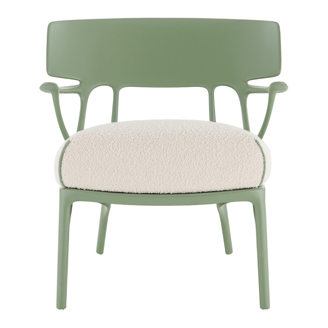 Green chair with soft cream-colored seat, accented by a textured pattern and smooth, sleek lines.