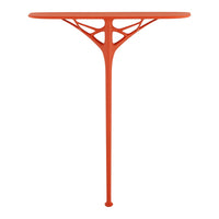 Bright orange table with a sleek, modern design featuring intricate cut-out patterns. Ideal for contemporary decor.
