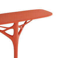Contemporary coral table with a smooth surface and organic branch-like legs in a vibrant, matte finish.