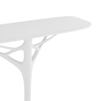 White table with a sleek, modern design featuring intricate, organic patterns in the base structure.