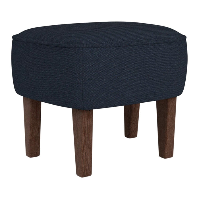 Navy blue upholstered ottoman with a smooth fabric finish and wooden legs in a rich brown tone.