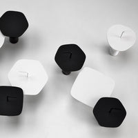 Black and white geometric shapes with hexagonal and square patterns on a light background. Modern minimalistic design.