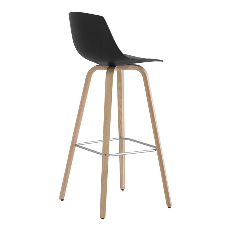 Black modern bar stool with smooth curves and natural wood legs, featuring a sleek silver footrest.