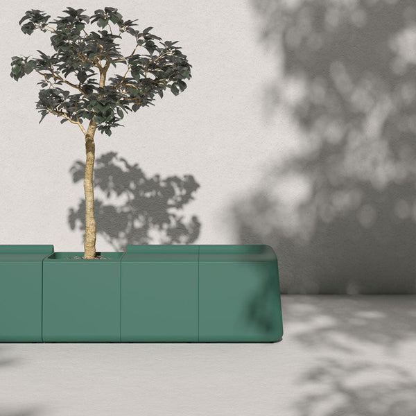 Teal planter with clean lines, featuring a shadow play from the tree above on a light gray backdrop.
