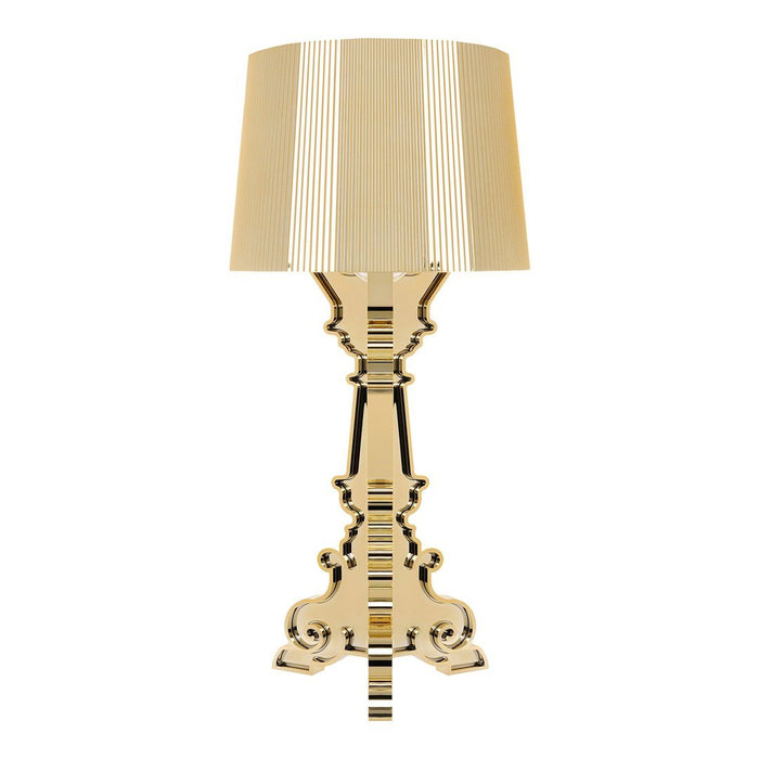Elegant gold lamp with a ribbed shade and ornate base, featuring a classic design in warm golden tones.