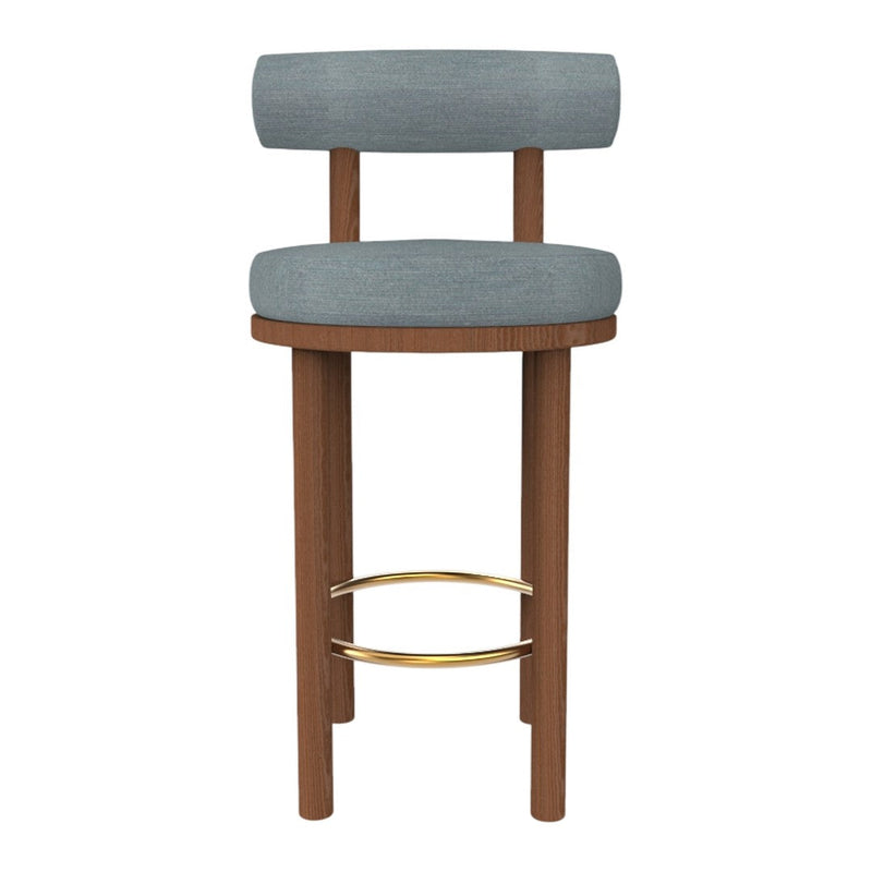 Gray upholstered bar stool with a wooden frame and gold accents. Modern design with a minimalist aesthetic.