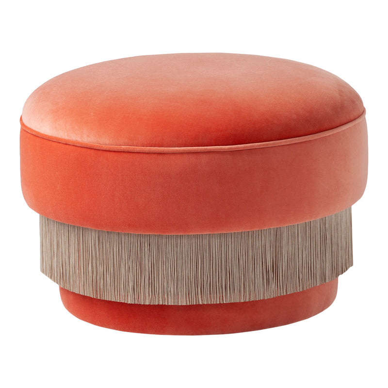 Orange velvet round ottoman with a textured fringe in a neutral beige. Chic and modern home decor accent.