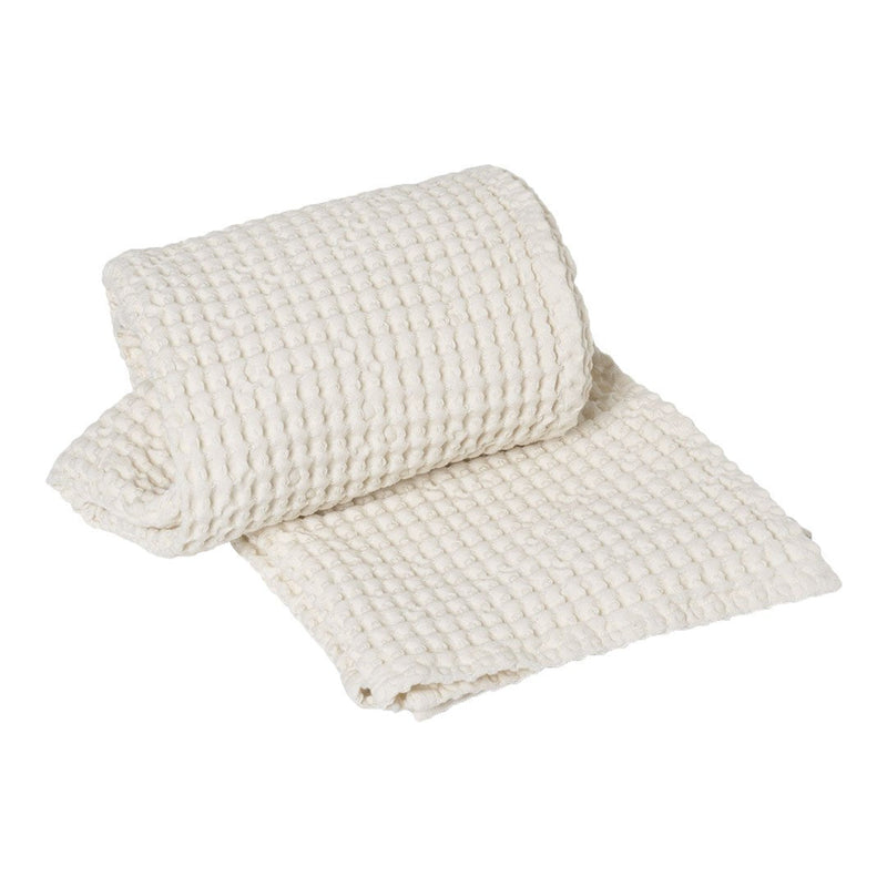 Woven cream-colored fabric roll with a textured, grid-like pattern, perfect for home decor or crafting projects.