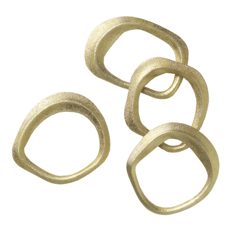 Set of four textured gold rings with varied circular shapes and smooth edges, showcasing a modern and elegant design.