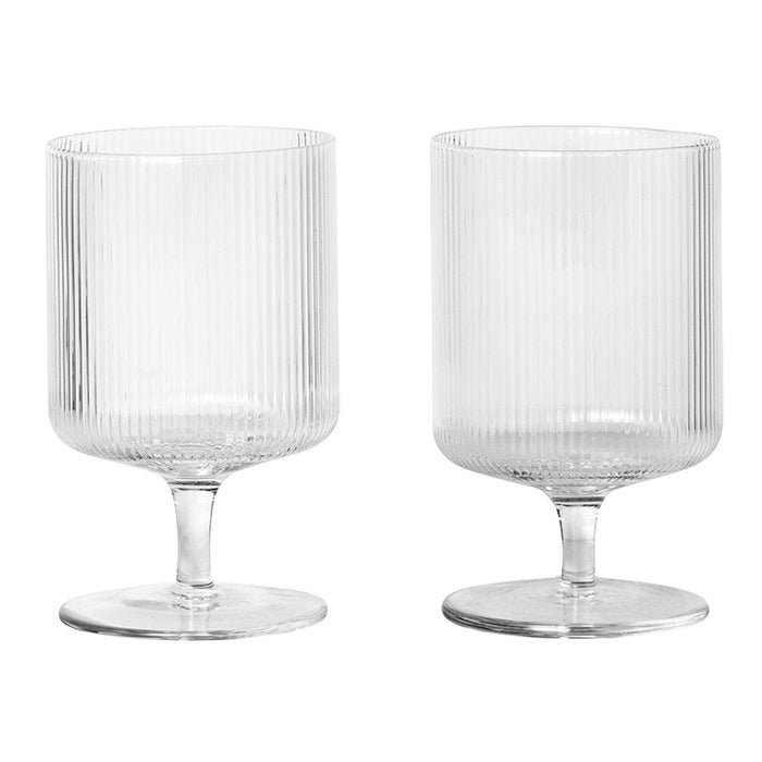 Clear glass cups with vertical ribbed patterns, elegant and stylish for any table setting. Perfect for drinks and desserts.