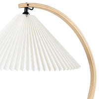 White pleated lampshade with a natural wood arch, showcasing a minimalist design and clean lines.