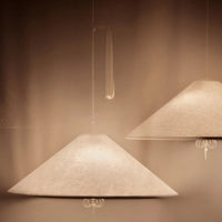 Neutral beige pendant lamps with a sleek, conical shape and subtle textured pattern. Perfect for modern interiors.