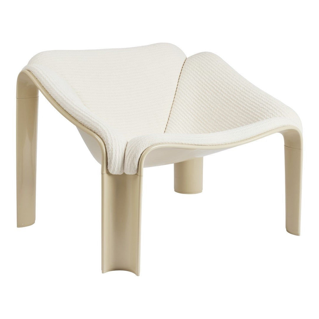 Cream-colored minimalist chair with textured surfaces and smooth, curved edges. Ideal for modern decor.
