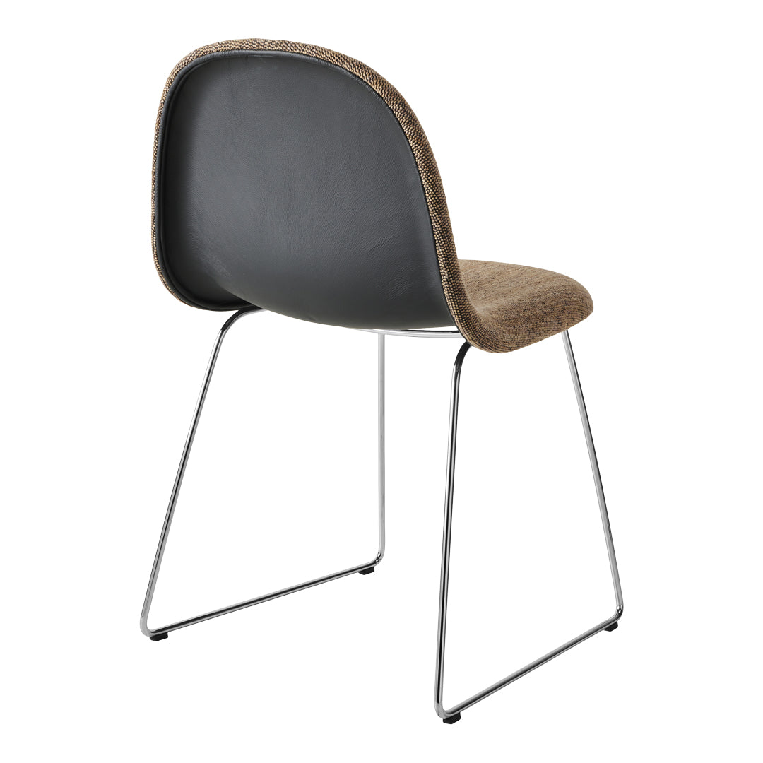 Black and beige patterned chair with a chrome base, featuring a sleek, modern design.