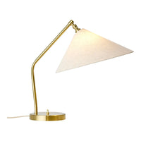 Gold metal desk lamp with a cream-colored fabric shade in a sleek, modern design.