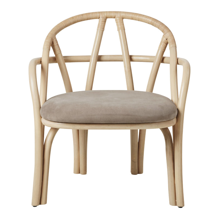 Beige velvet seat cushion on a natural rattan chair with curved bamboo frame, showcasing a minimalist design.