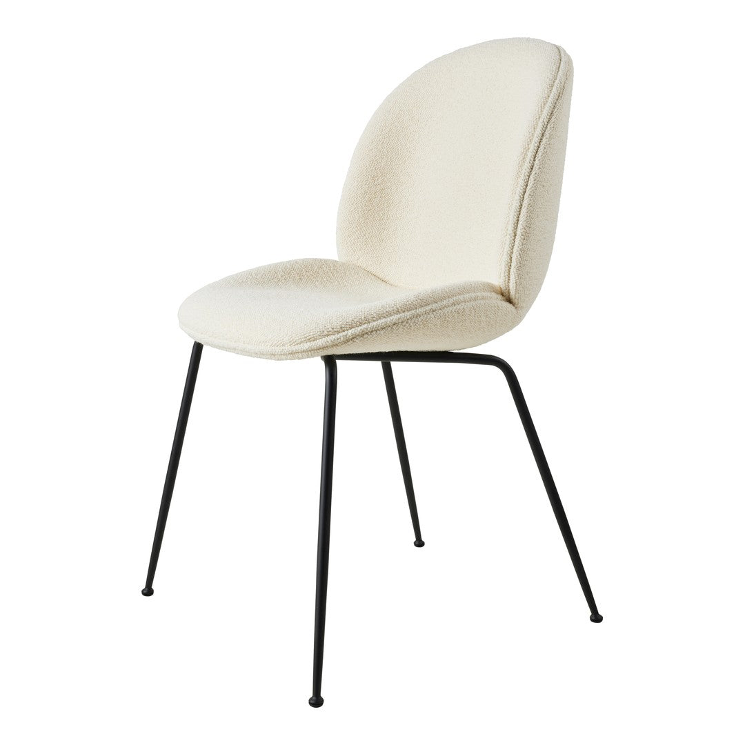 Cream-colored chair with textured upholstery and sleek black legs, perfect for modern decor.