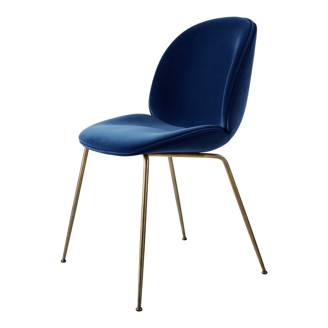 Elegant blue velvet chair with smooth, curvy seat and sleek brass legs. Perfect for modern decor.