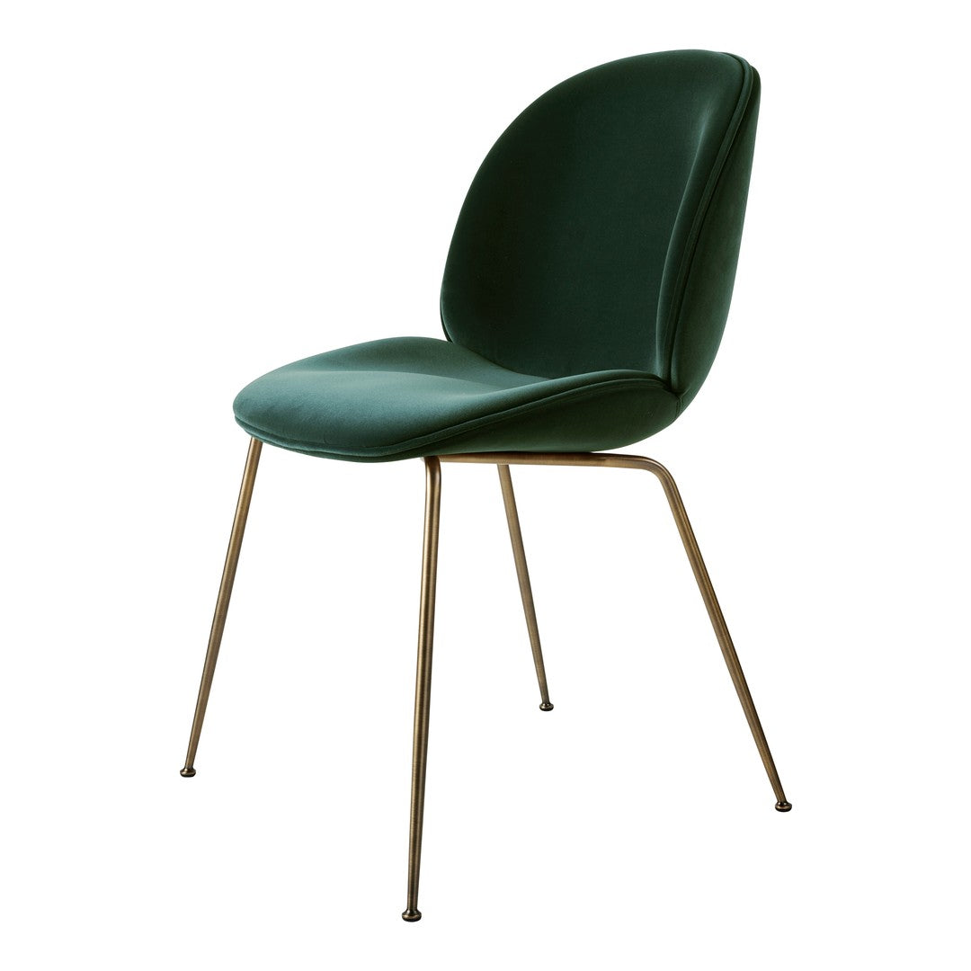 Green upholstered chair with smooth curves and sleek gold legs, perfect for modern decor.
