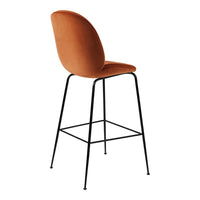 Stylish orange velvet barstool with a sleek black metal frame and minimalist design. Perfect for modern interiors.