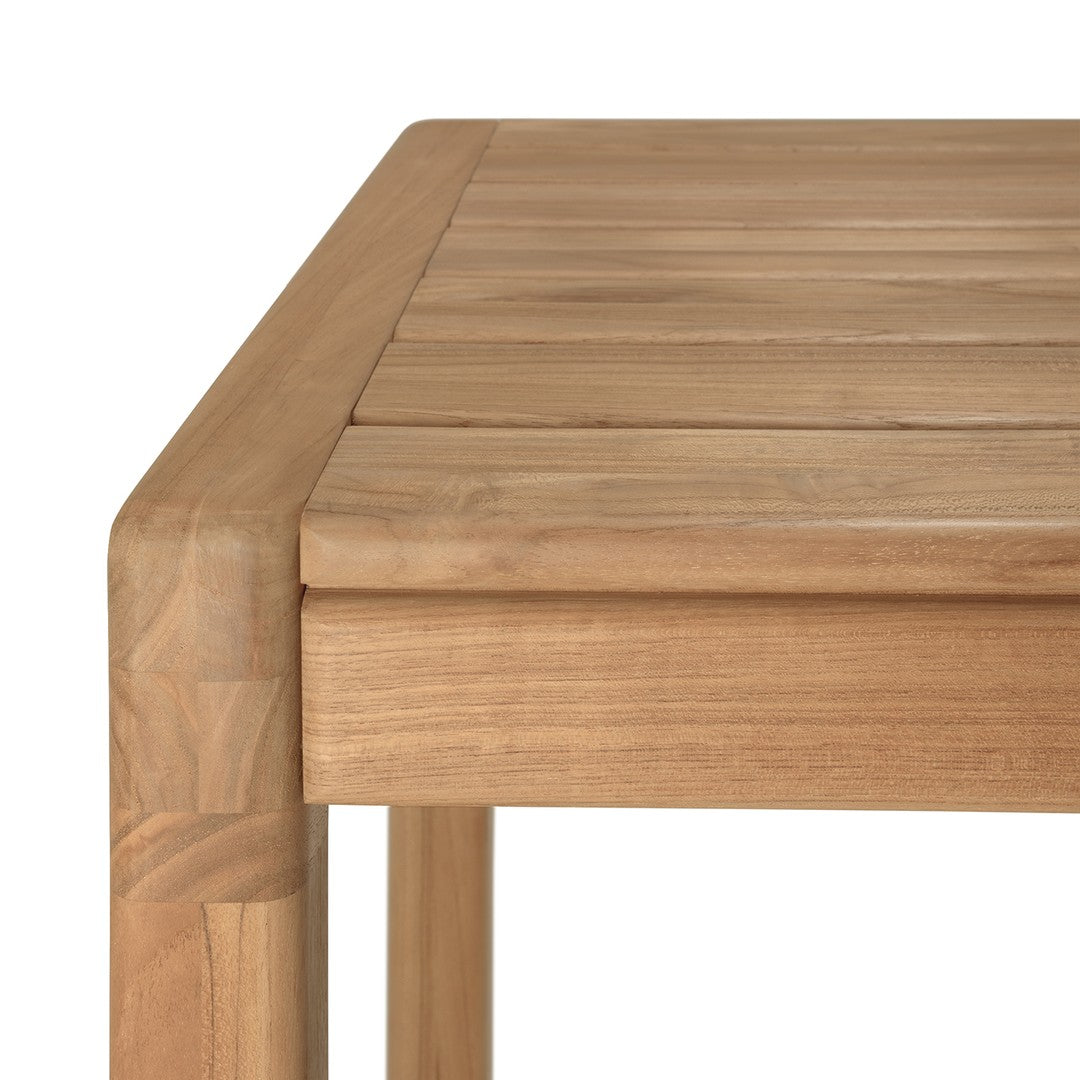 Light brown wooden table with a smooth, slatted surface and rounded corners, showcasing natural wood grain patterns.