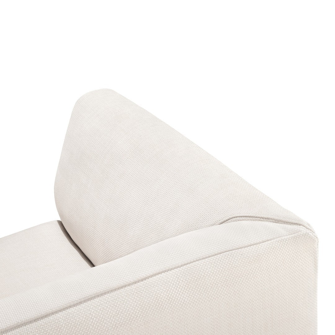 Cream-colored fabric sofa corner with a smooth, textured finish, featuring a minimalist design and clean lines.