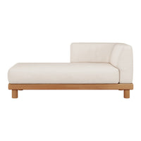 Cream chaise lounge with a minimalist design and natural wood base, featuring smooth lines and a contemporary aesthetic.