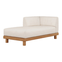 "Neutral beige chaise lounge with a smooth, minimalist design and light wood base."