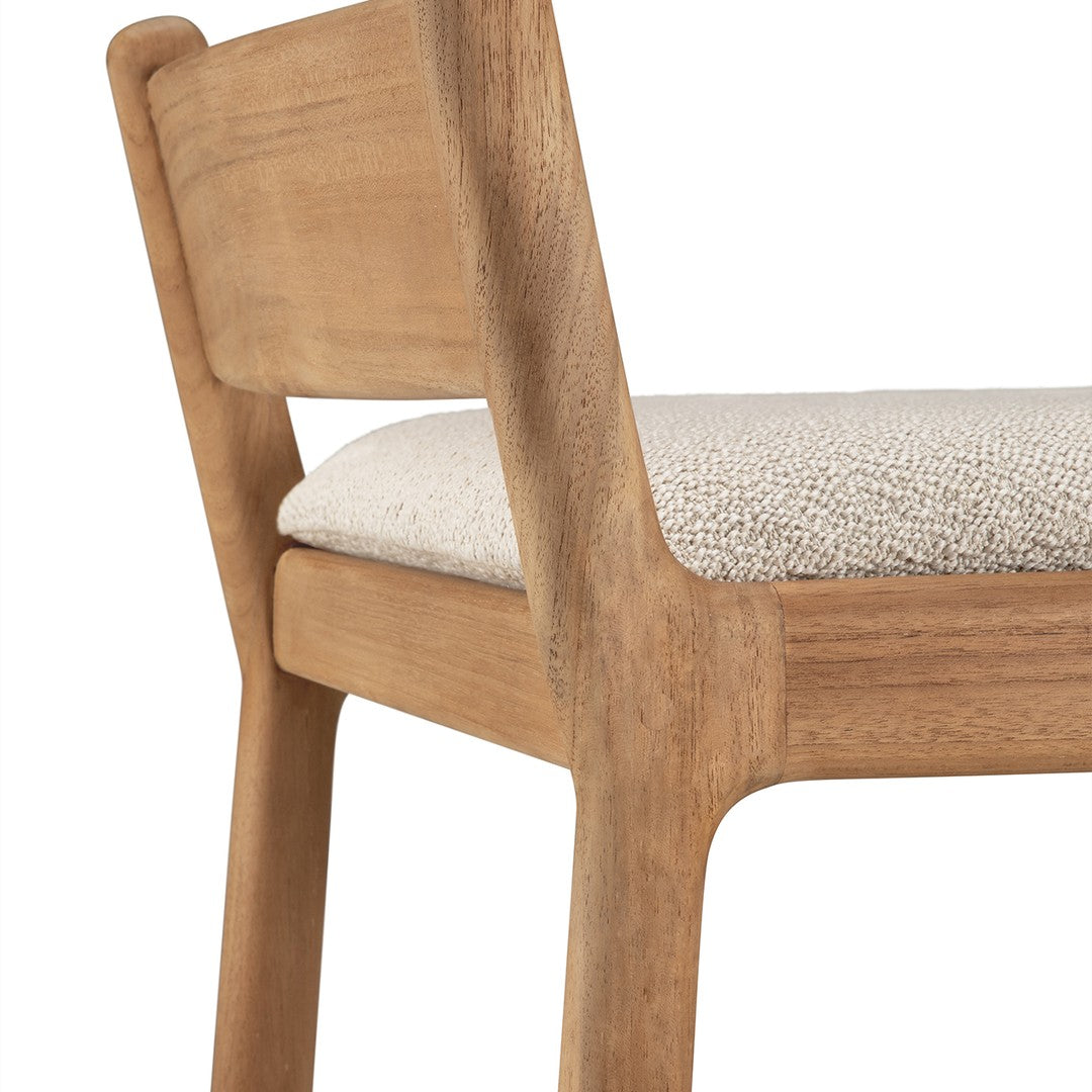 Natural wood chair with a light beige padded seat featuring a subtle textured pattern.