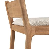 Natural wood chair with a light beige padded seat featuring a subtle textured pattern.