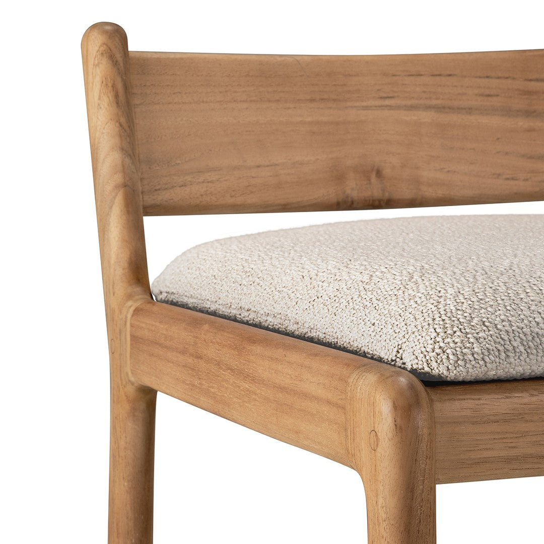 Natural wood chair with a smooth finish and a soft cream-colored textured seat. Perfect for modern decor.