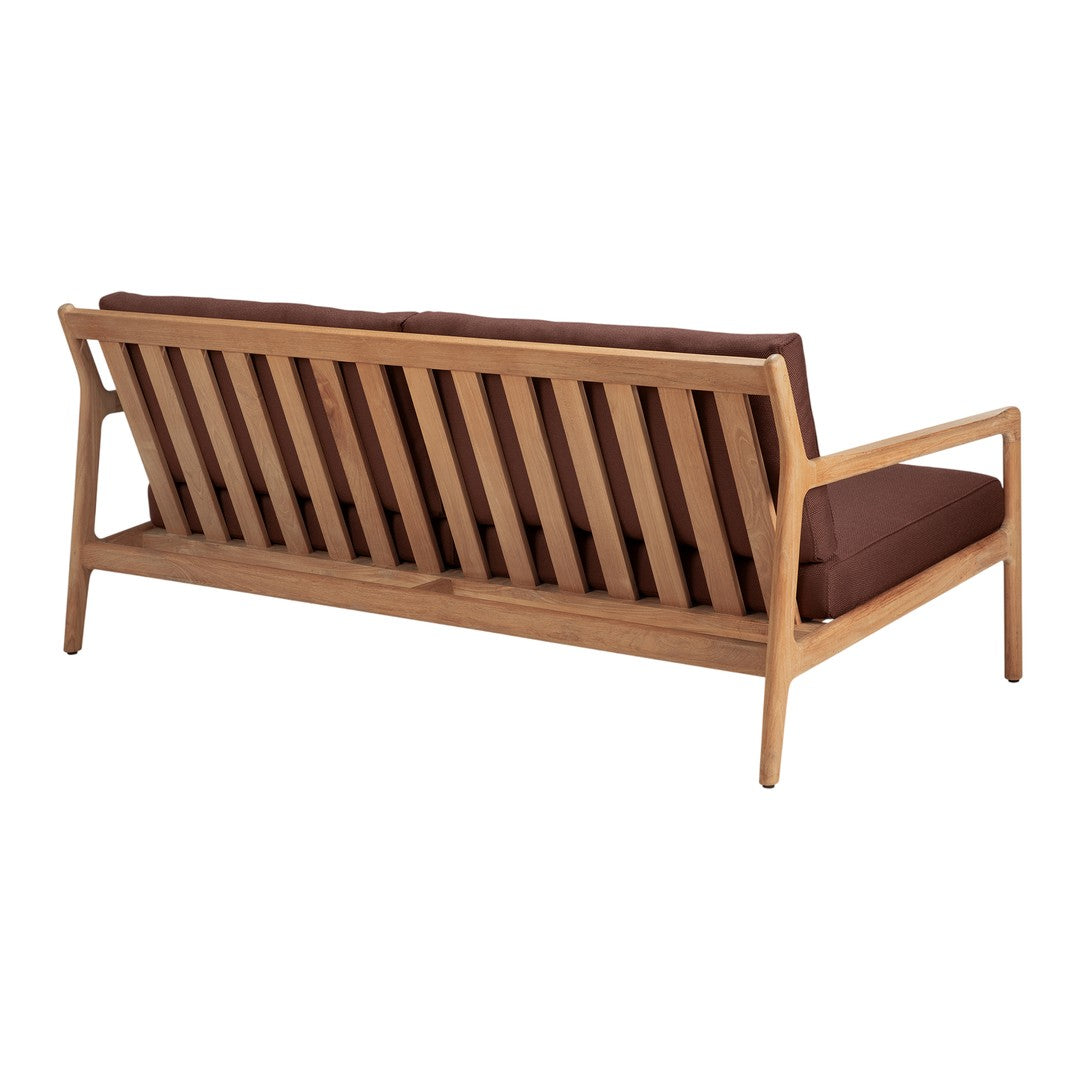 Brown cushions on a slatted natural wood sofa with a minimalist design. Clean lines and warm tones for modern decor.