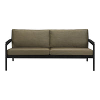 Olive green fabric cushions on a sleek black metal frame couch, perfect for modern decor.