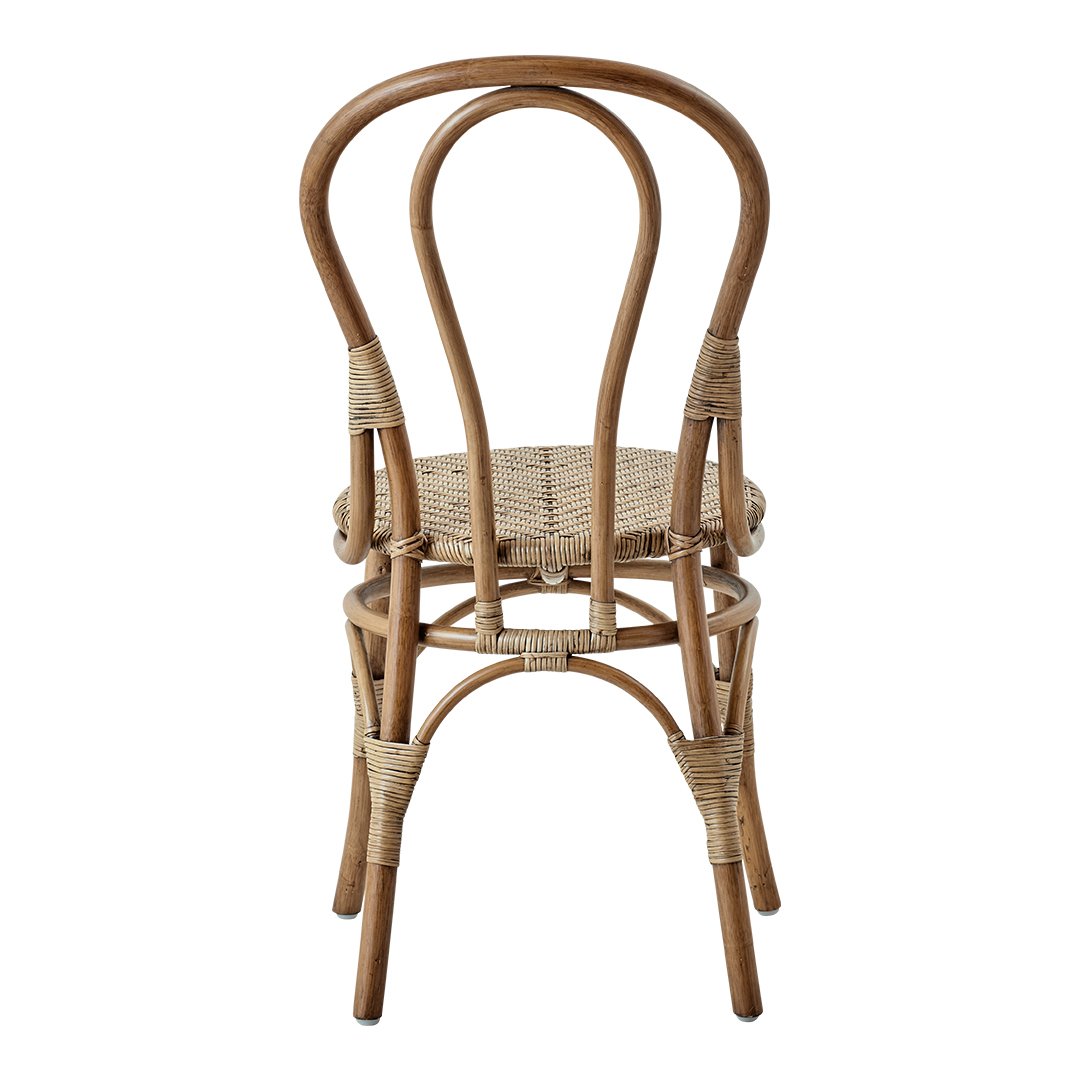 Natural rattan chair with a woven seat, featuring a minimalist design and earthy tones. Perfect for a cozy setting.