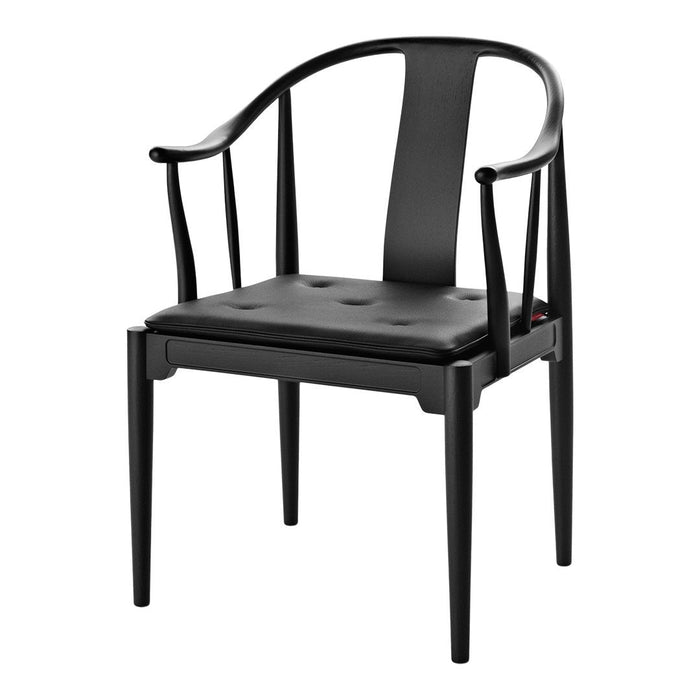 Black chair with smooth, sleek finish and minimalist design. Classic solid color with no visible patterns.