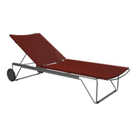 "Modern chaise lounge with a sleek red slatted design and minimalist gray metal frame, perfect for outdoor relaxation."